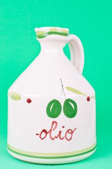 Bottle of olive oil on the green background