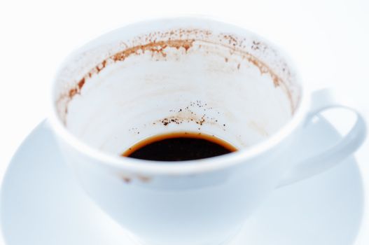 Drunk coffee cup and saucer on white background close up