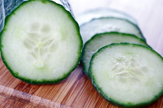Sliced ​​cucumber on a wooden board close up