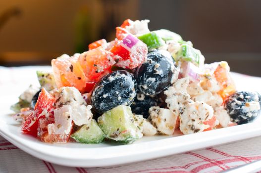 Greek salad on a waffle napkin close up