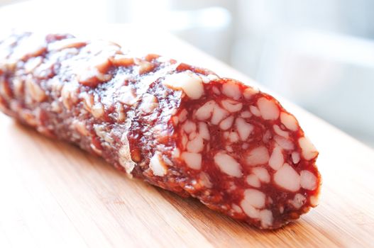 Smoked sausage on a wooden board close up