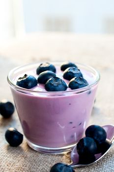 Ripe blueberries in the yogurt close up