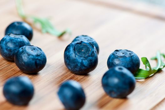 Large blueberries on a wooden board close up