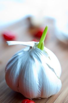 Garlic on a cutting wooden board close up