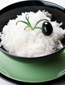 White steamed rice in black round bowl