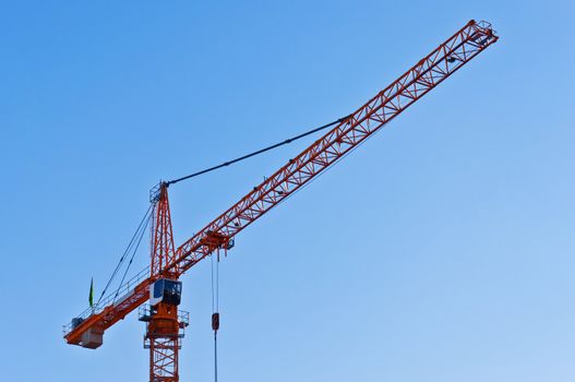 Industrial construction: yellow crane against blue sky