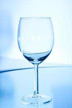 Glass on the table on blue background