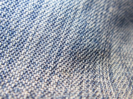 A background of an uneven blue denim fabric.                               