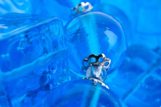 Blue glass beads background close up