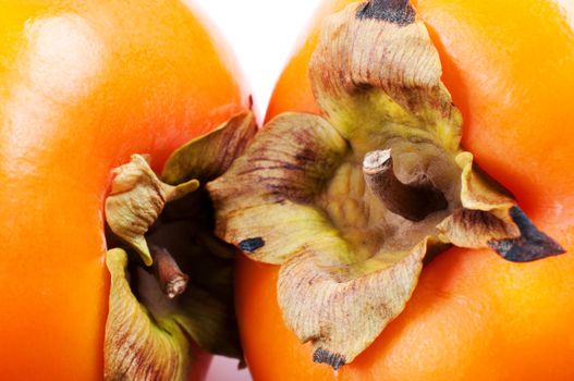 Persimmons on white background close up
