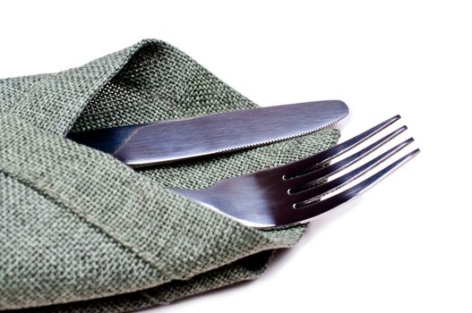 Knife and fork on green napkin