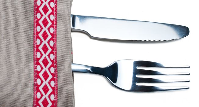 Knife and fork on gray napkin close up
