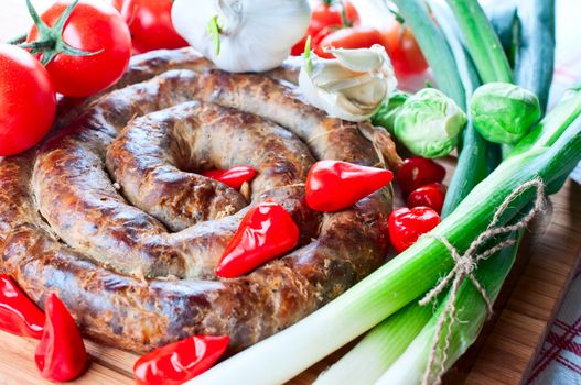 Sausage with spices and tomatoes close up