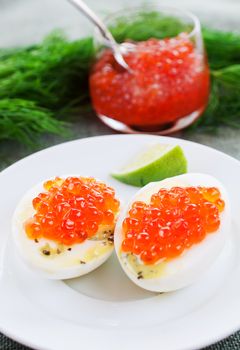 Eggs and caviar on white dish