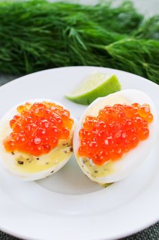 Boiled eggs and caviar on white dish