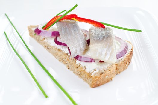 Sandwich with marinated herring bites and creame cheese