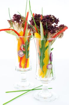 Cutted vegetables in two glasses