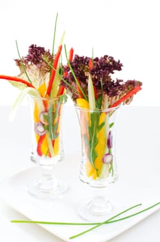 Cutted vegetables in glasses
