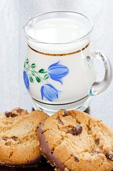 Сhocolate cookies and milk in a jug