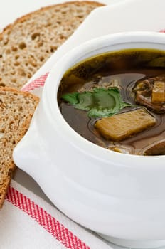 Mushroom soup in white bowl with bread