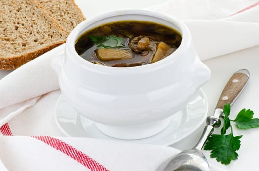Mushroom soup in white bowl with bread