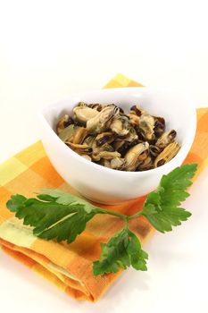 mussels with italian parsley in a bowl on bright background