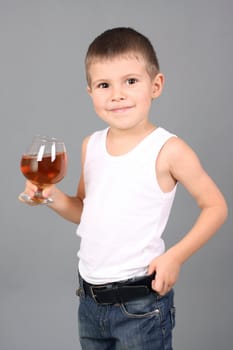 The boy holds a glass with cognac