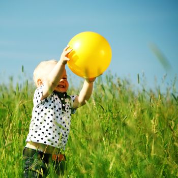 young smile boy play yellow ball