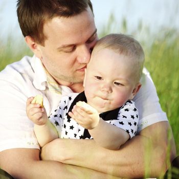 father and son in the grass