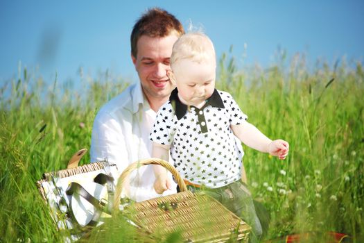 father and son in the grass