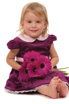 A very cute toddler with flowers