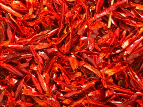 close up of red dried chili flakes food background