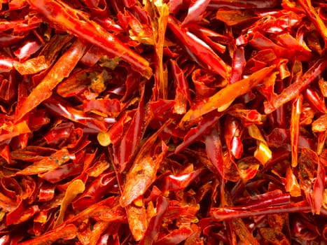 close up of red dried chili flakes food background