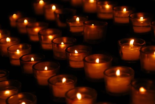 Charity. Lignting of Praying candles in a temple.