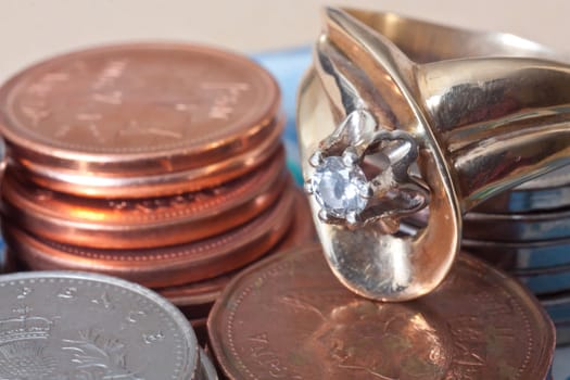 Close up photo of coins and golden ring.