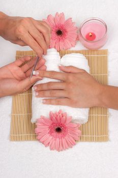 Male manicurist doing manicure to a female customer