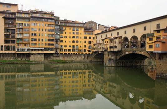 The bridge Ponte Vecchio in Florence and its reflection