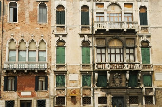The facades of Venetian houses with balconies and windows