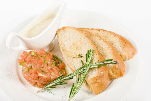 Tar-tar from salmon fish with green onion. Served with honey sauce and white bread toast.