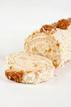 Chocolate Swiss roll closeup isolated on a white background