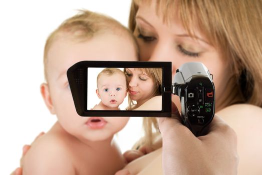 Happy maternity: mother with her baby boy isolated on a white at camcorder