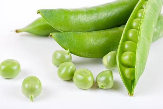 Ripe pea vegetable with green leaf isolated on white background