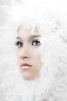 Girl with beautiful make up and white feathers