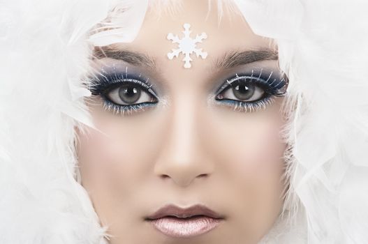 Girl with beautiful make up and white feathers