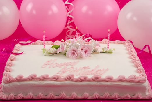 Delicious beautifully decorated bithday cake and balloons