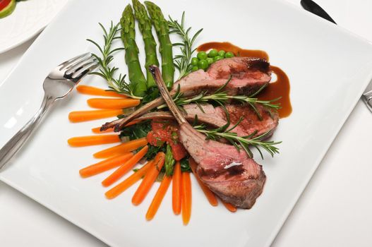 Gourmet lamb chop with vegetables, herbs and balsamic vinegar