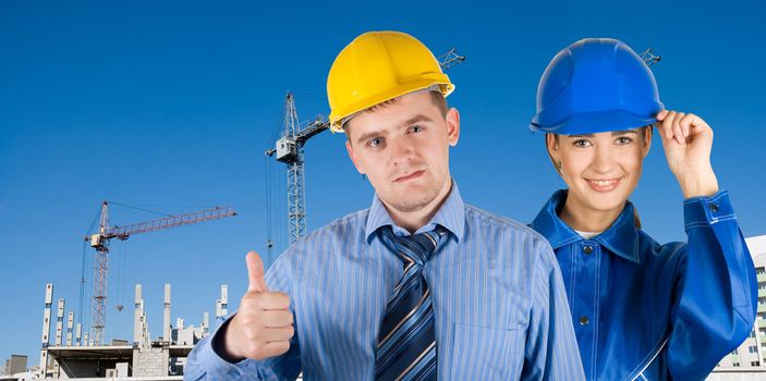 Portrait of architects at in front of construction site, building and crane.