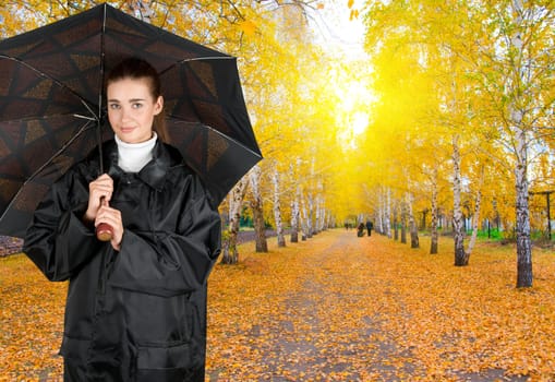 pretty brunette girl at black coat under umbrella