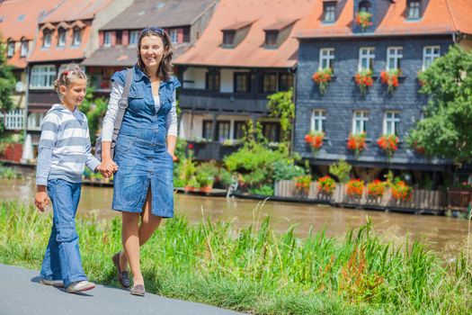 Tourists. Beautiful mother and daughter walking in europe city.