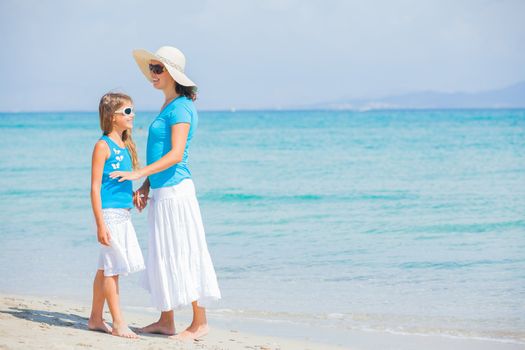 Mother and her daughter having fun on tropical beach